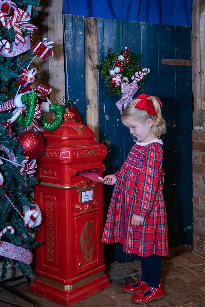 Young girl posts a letter to santa at lillingstone pick your own