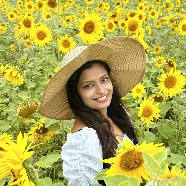 Summer Adventures 18 Shamika, a customer from lillingstone pick your own, stands in the sunflower fields