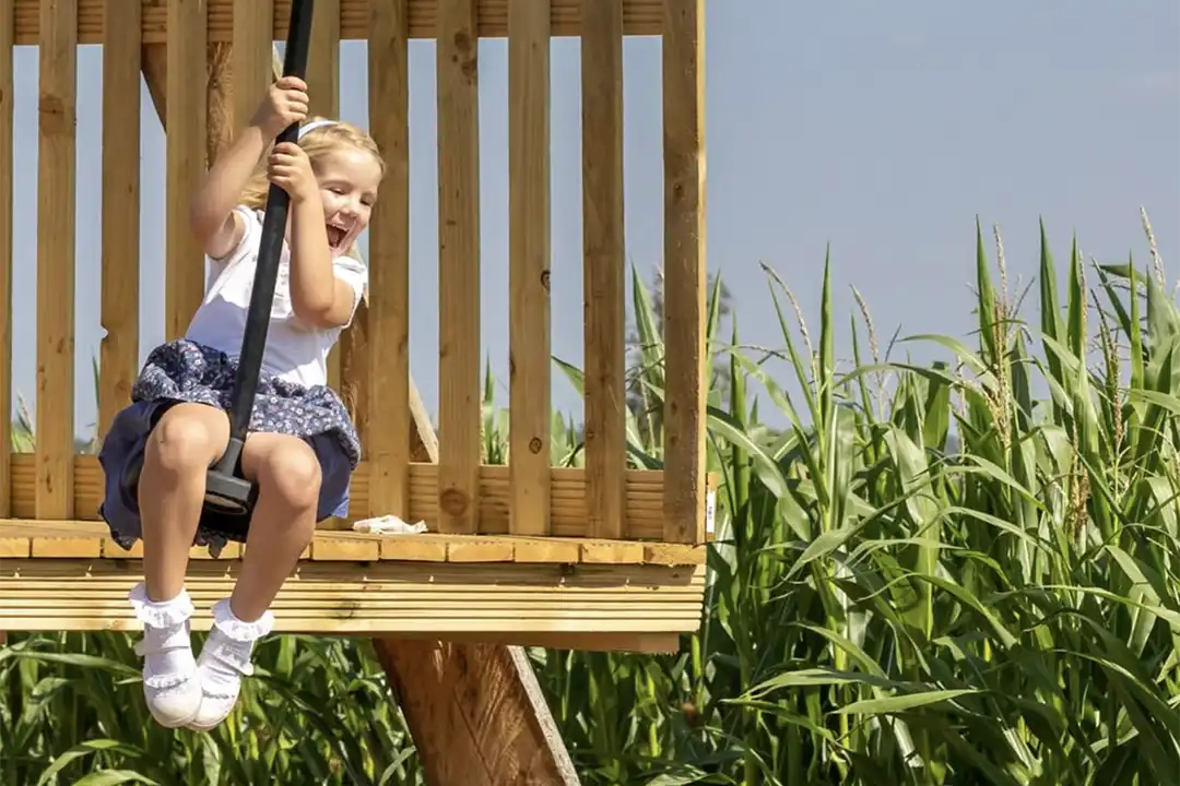 A young girl sets off on a zipline in the play patch at Lillingstone Pick Your Own farm